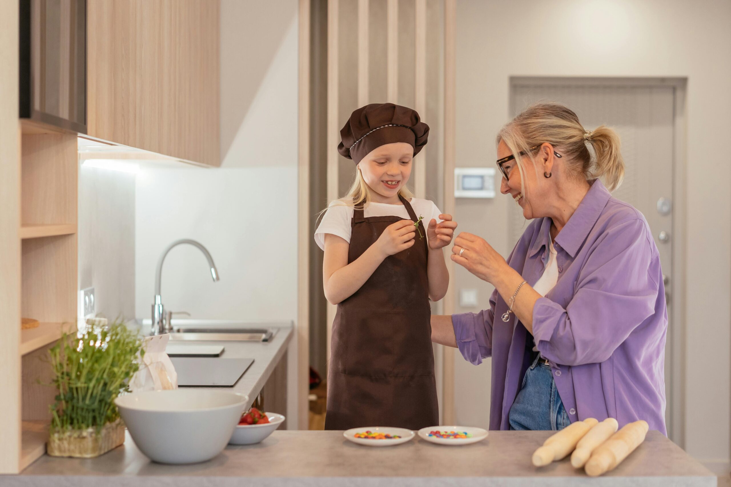Child preparing a healthy snack with fresh fruits and vegetables in a kitchen