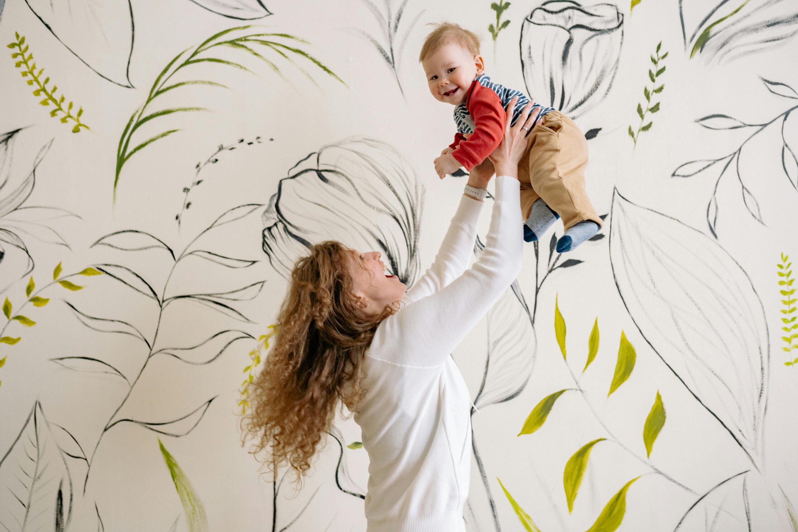 A parent holding hands with a child at different life stages.