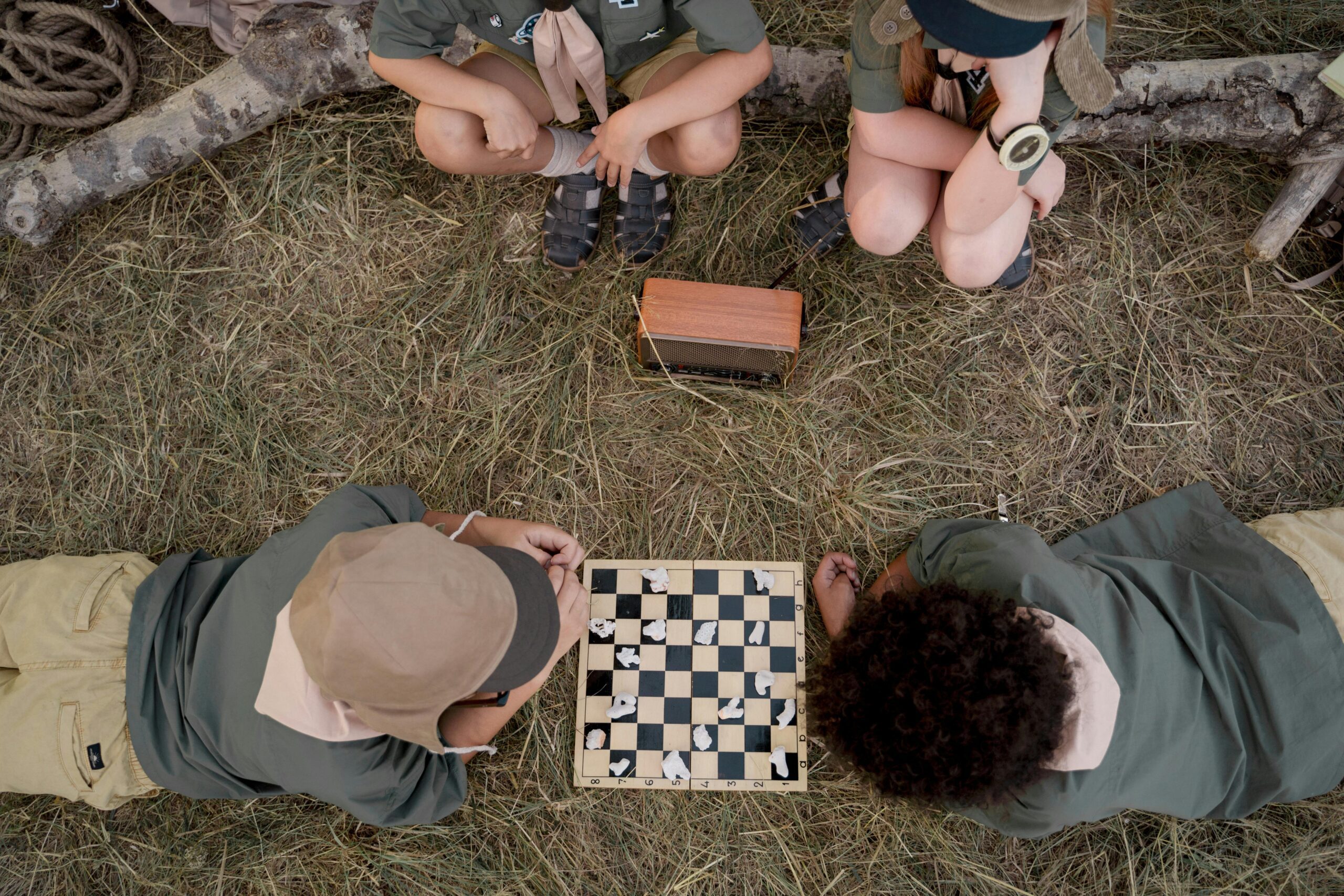 Children playing various board games, including Candy Land, Scrabble Junior, and Catan Junior
