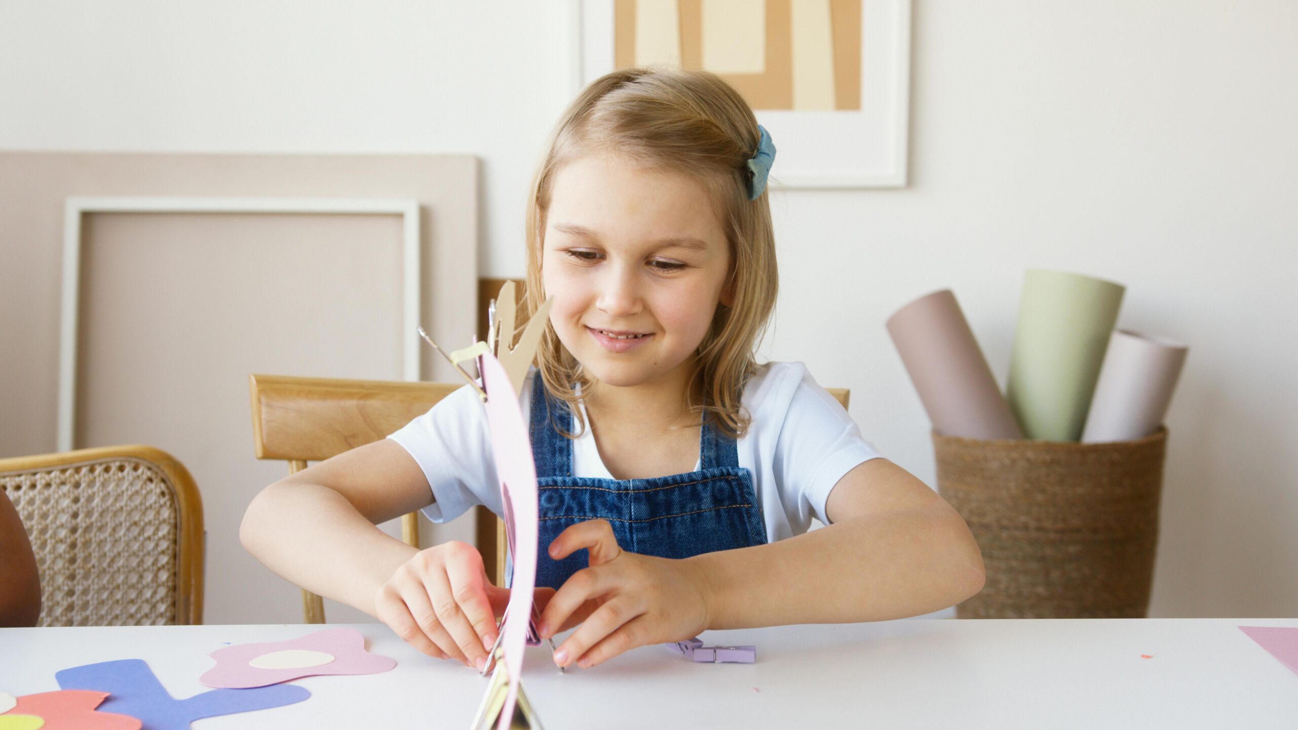 A child happily doing homework with colorful school supplies around.