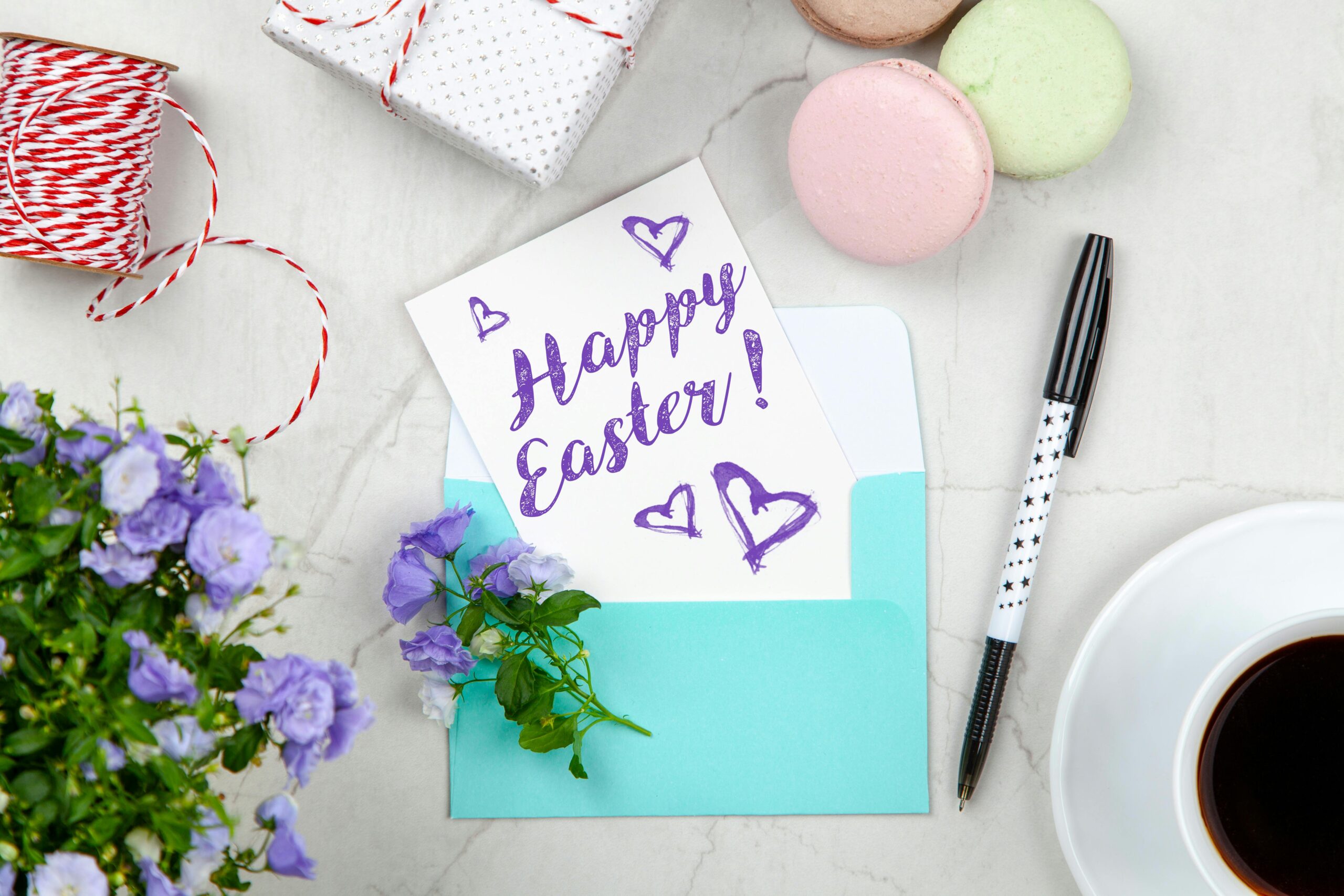 Colorful Easter eggs, flowers, and springtime decorations arranged on a wooden table